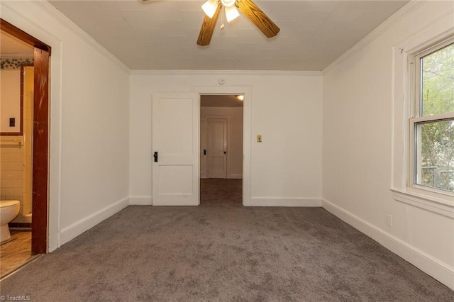 unfurnished bedroom with ensuite bath, carpet flooring, baseboards, and ornamental molding