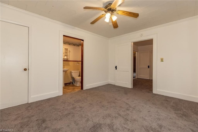 unfurnished bedroom with carpet, baseboards, ensuite bathroom, and ornamental molding