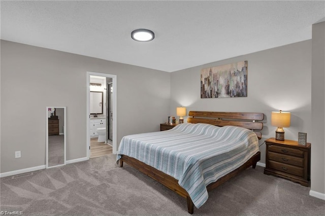 bedroom featuring carpet flooring, ensuite bath, and baseboards