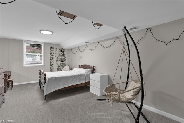 carpeted bedroom featuring lofted ceiling, visible vents, and baseboards