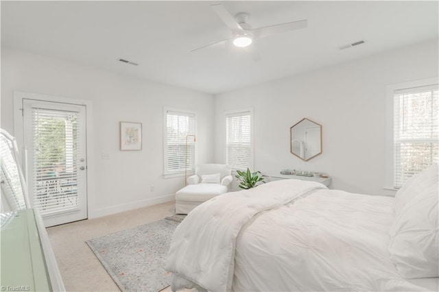 carpeted bedroom featuring multiple windows, access to exterior, and ceiling fan