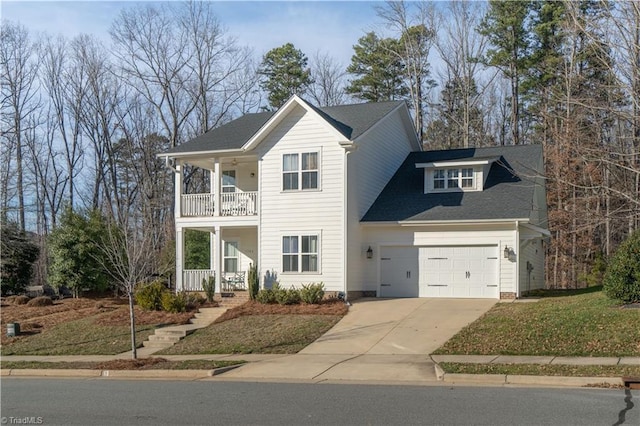 view of front facade with a garage, a front yard, a balcony, and covered porch