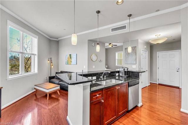 kitchen featuring sink, hanging light fixtures, stainless steel dishwasher, ceiling fan, and dark stone countertops