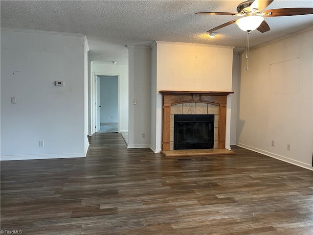 unfurnished living room featuring crown molding, a textured ceiling, ceiling fan, hardwood / wood-style flooring, and a tile fireplace