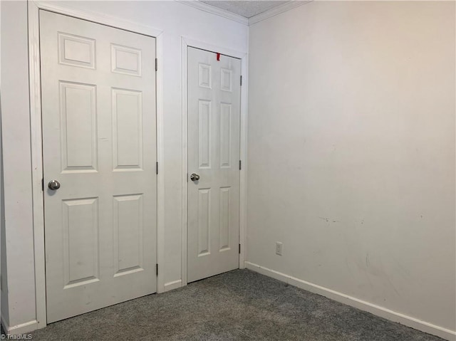 unfurnished bedroom featuring dark colored carpet and crown molding