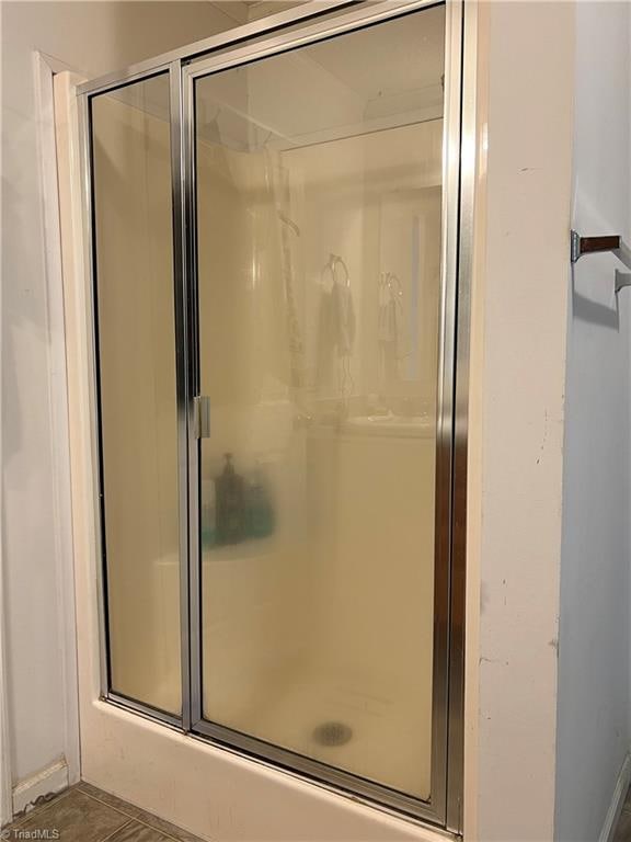 bathroom with a shower with shower door