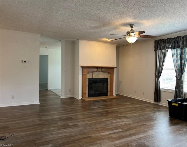 unfurnished living room featuring a tile fireplace, a textured ceiling, ceiling fan, and wood-type flooring