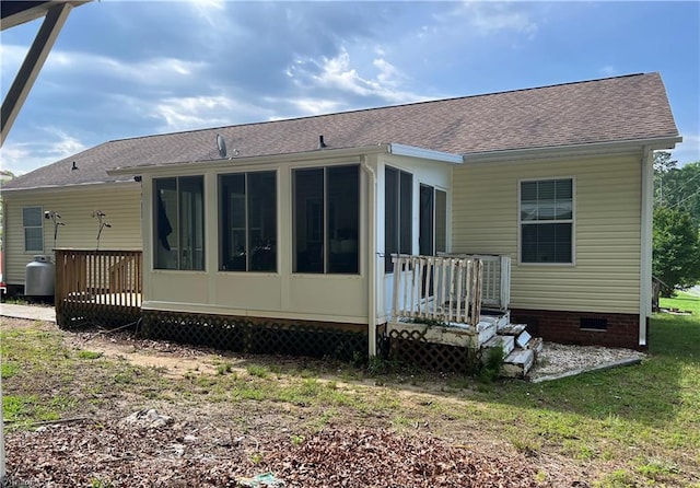 rear view of property featuring a sunroom