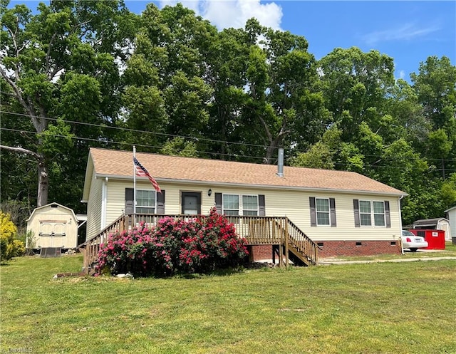 view of front facade with a front lawn and a storage unit