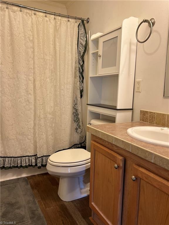 bathroom with vanity, toilet, and hardwood / wood-style floors