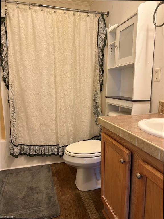 bathroom with vanity, toilet, and hardwood / wood-style floors