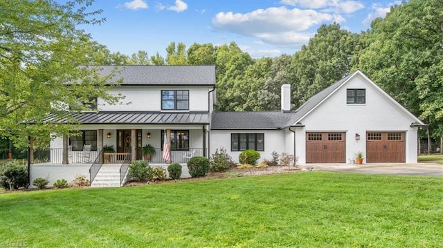 modern inspired farmhouse featuring a garage, a front lawn, and a porch