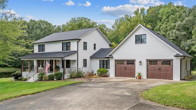 modern inspired farmhouse with covered porch and a front lawn