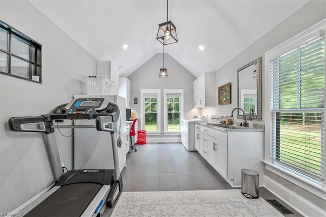 exercise area with sink, dark wood-type flooring, high vaulted ceiling, and washer / clothes dryer