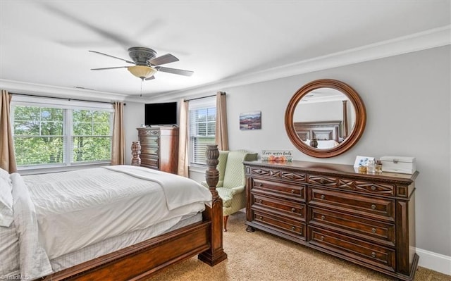 bedroom featuring crown molding, multiple windows, light colored carpet, and ceiling fan