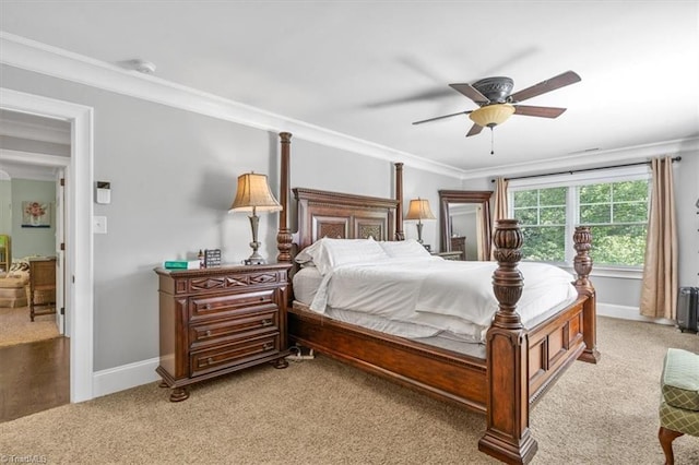 carpeted bedroom featuring ceiling fan and ornamental molding