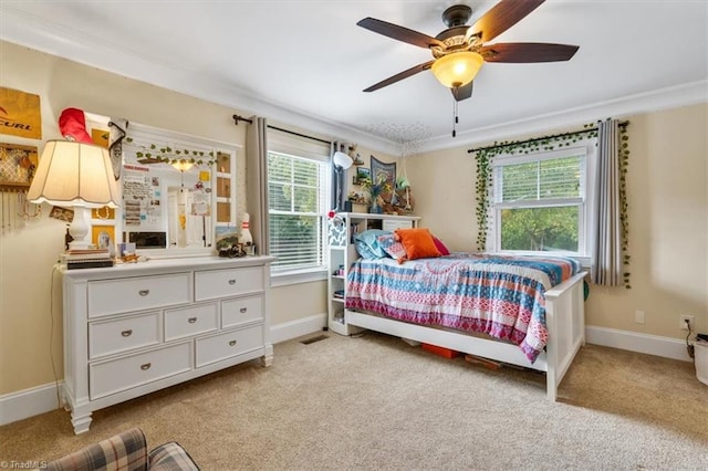 carpeted bedroom featuring ornamental molding, multiple windows, and ceiling fan