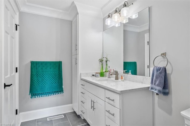 bathroom with vanity, crown molding, and tile patterned flooring