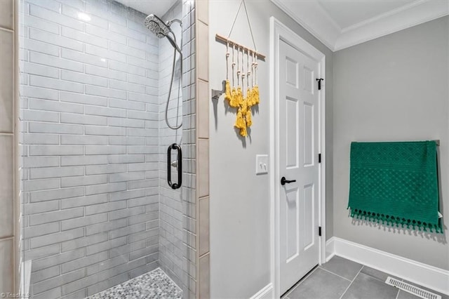 bathroom with tile patterned floors, a shower with shower door, and ornamental molding