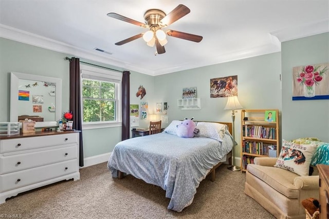 carpeted bedroom with ceiling fan and crown molding