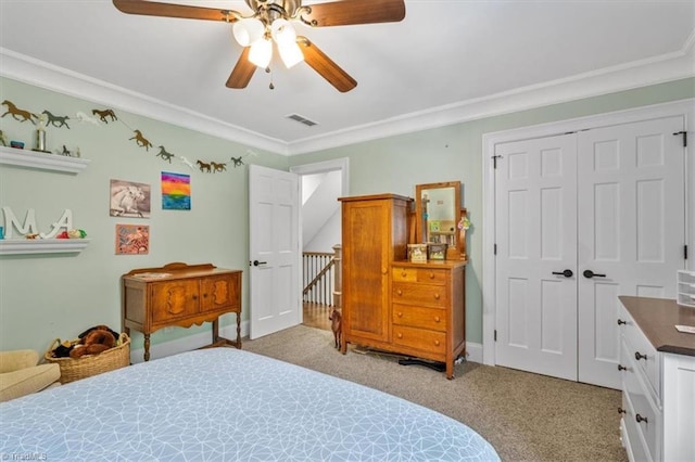 bedroom with a closet, ceiling fan, light carpet, and ornamental molding