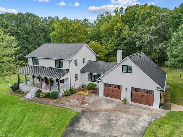 modern farmhouse style home with a porch and a front lawn