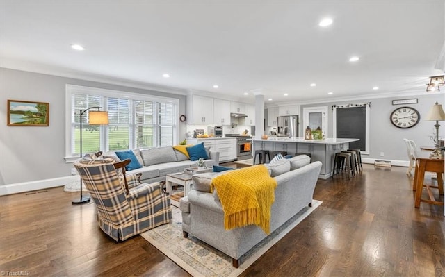 living room featuring ornamental molding and dark hardwood / wood-style floors