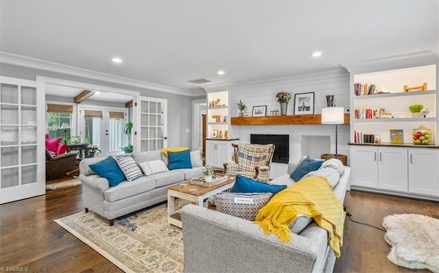 living room featuring ornamental molding, french doors, dark hardwood / wood-style floors, and a brick fireplace