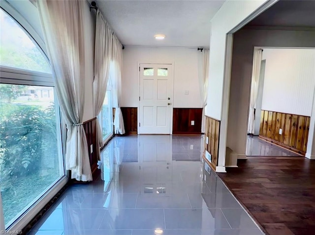 entrance foyer with a healthy amount of sunlight and wood walls