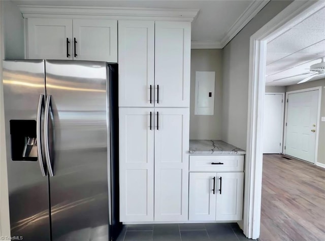 kitchen featuring stainless steel refrigerator with ice dispenser, white cabinetry, hardwood / wood-style floors, light stone countertops, and ceiling fan