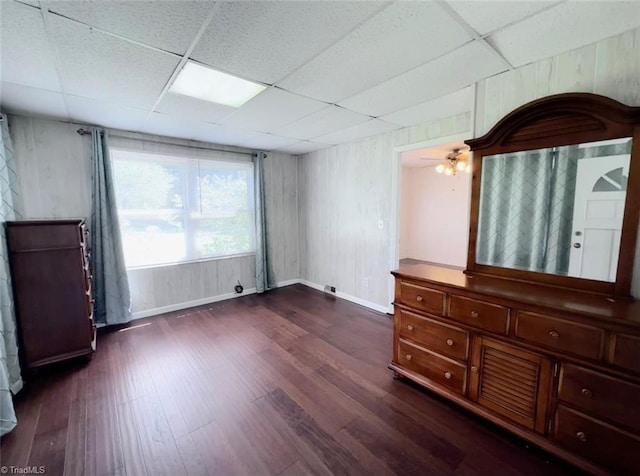 bedroom with dark hardwood / wood-style flooring and a paneled ceiling