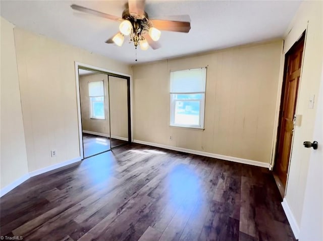 unfurnished bedroom with a closet, ceiling fan, and dark hardwood / wood-style flooring