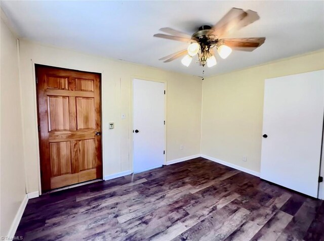 interior space with ceiling fan and dark wood-type flooring