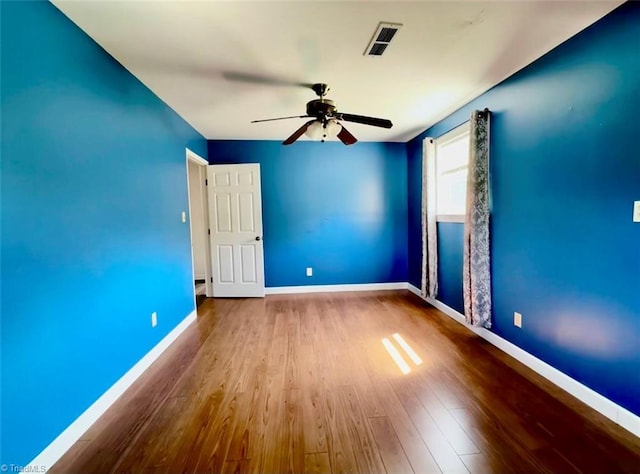 unfurnished room featuring ceiling fan and hardwood / wood-style flooring