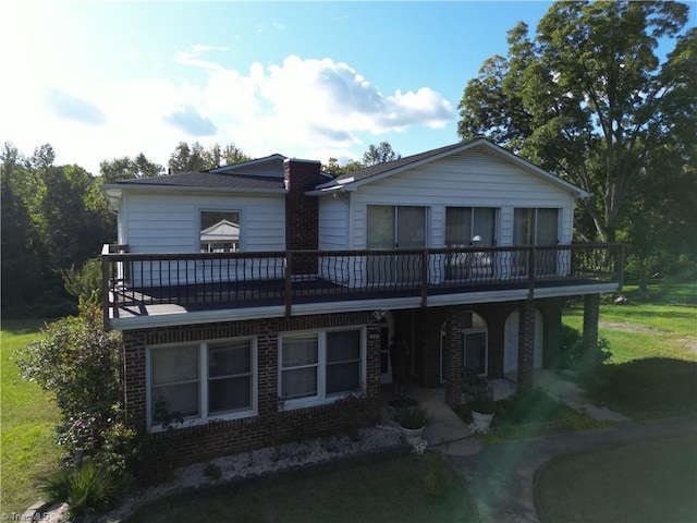 rear view of property with a lawn