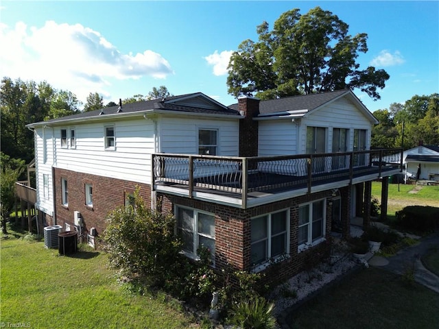 back of house with a lawn and cooling unit