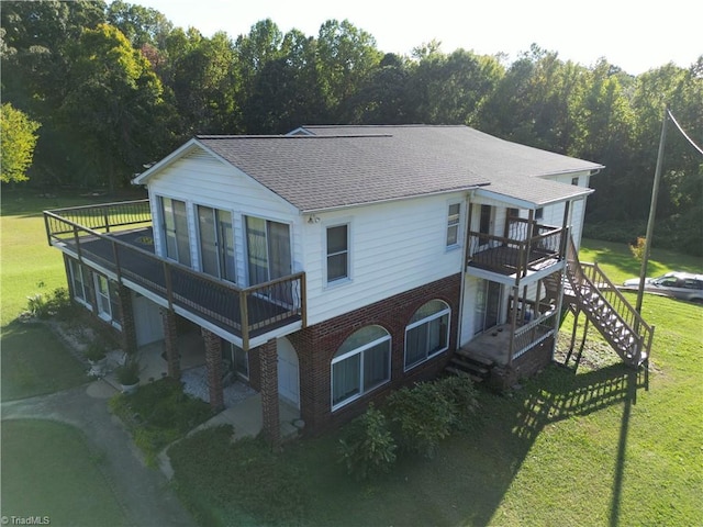 rear view of property featuring a yard and a wooden deck