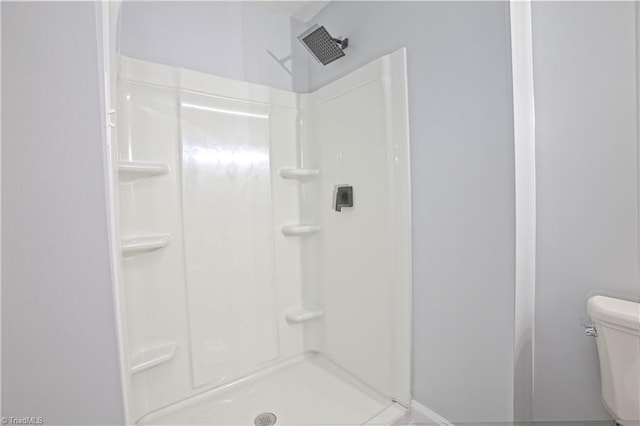 bathroom with toilet and walk in shower