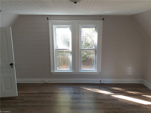 bonus room with dark hardwood / wood-style floors and lofted ceiling