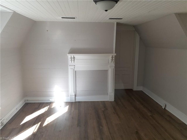 additional living space with dark hardwood / wood-style flooring, wood ceiling, and lofted ceiling