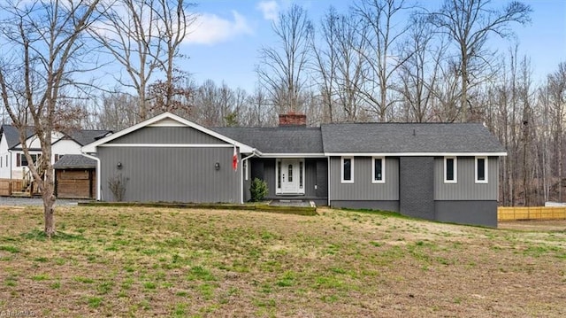 ranch-style house with a garage, fence, roof with shingles, a chimney, and a front yard