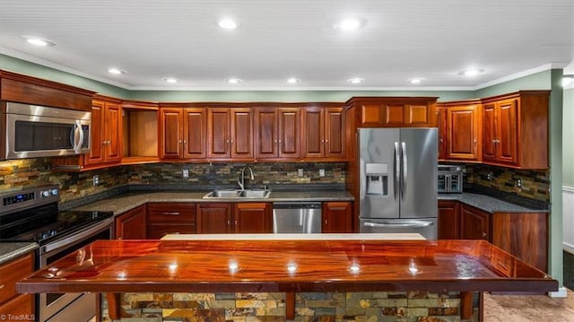 kitchen featuring stainless steel appliances, dark countertops, a sink, and backsplash