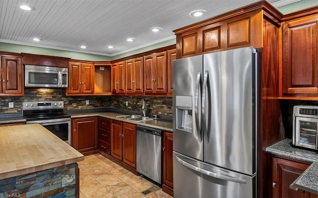 kitchen with a toaster, appliances with stainless steel finishes, a sink, backsplash, and recessed lighting