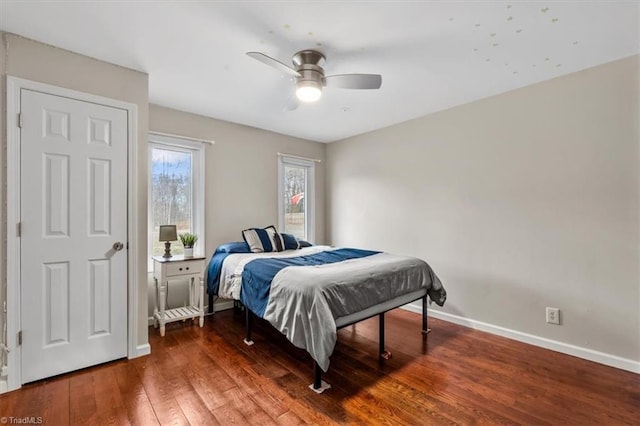 bedroom featuring baseboards, ceiling fan, and hardwood / wood-style floors