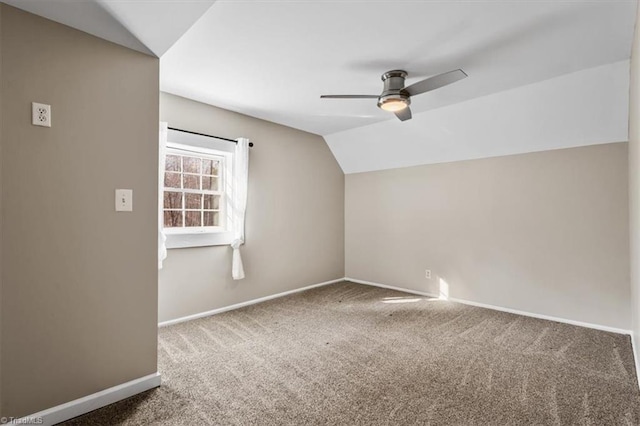 additional living space with lofted ceiling, ceiling fan, baseboards, and carpet flooring