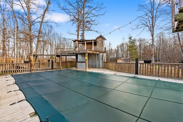 view of pool featuring a fenced in pool, fence, and a wooden deck