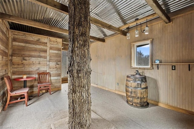 interior space with carpet flooring and beam ceiling