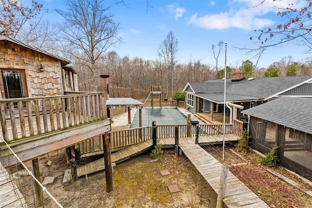 deck featuring a fenced in pool