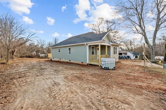 view of home's exterior with roof with shingles and crawl space