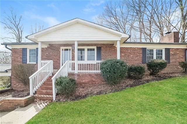 ranch-style home with covered porch and a front yard